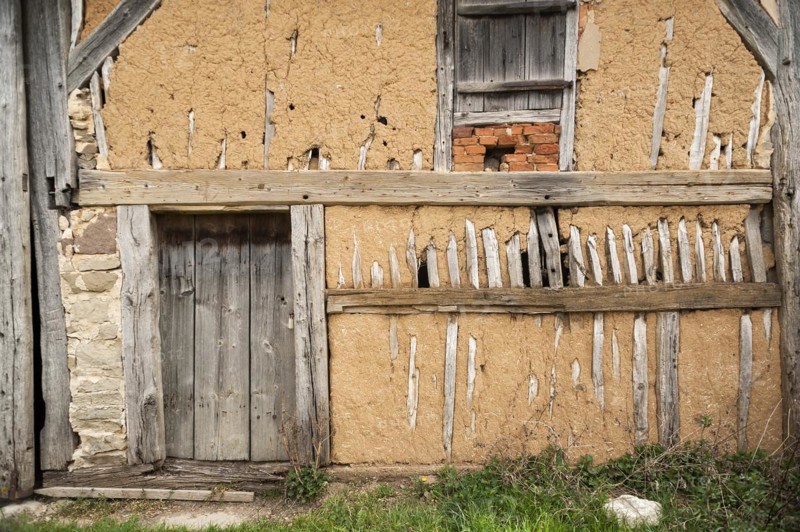 Exposed clay plaster wall of a barn