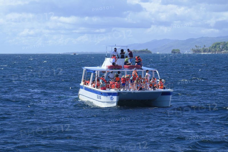 Tourists on a whale watching boat in Samana Bay