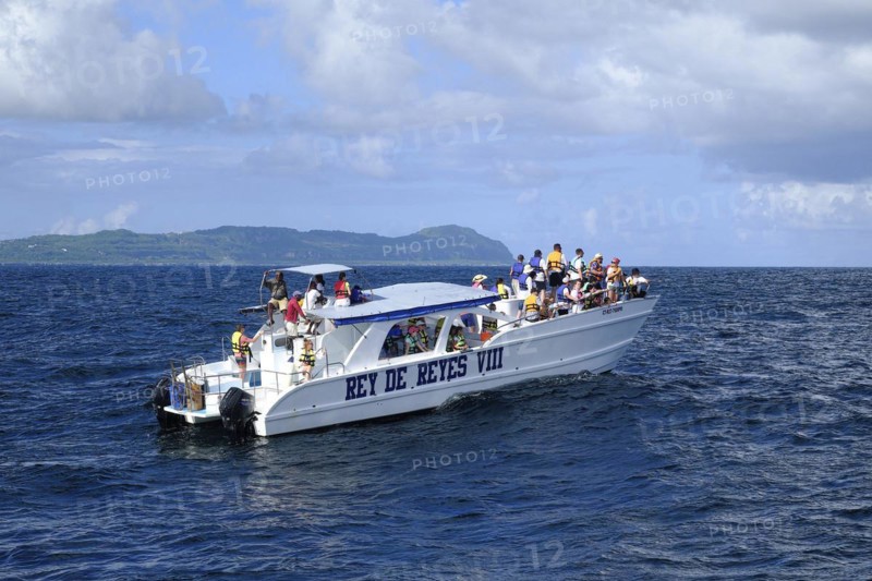 Tourists on a whale watching boat in Samana Bay