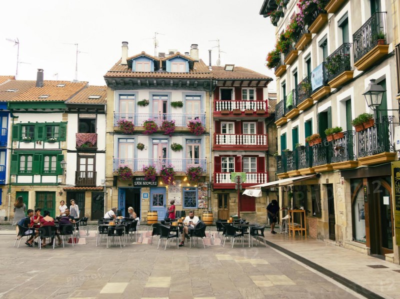 People sitting in the market place of Hondarribia