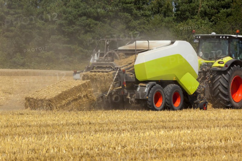 Tractor with a straw baler