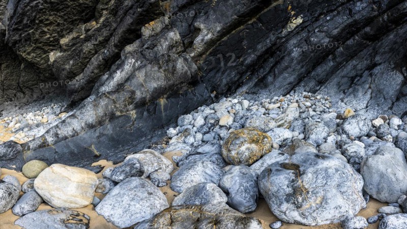 Rocky coast and colourful stones at Praia da Adraga