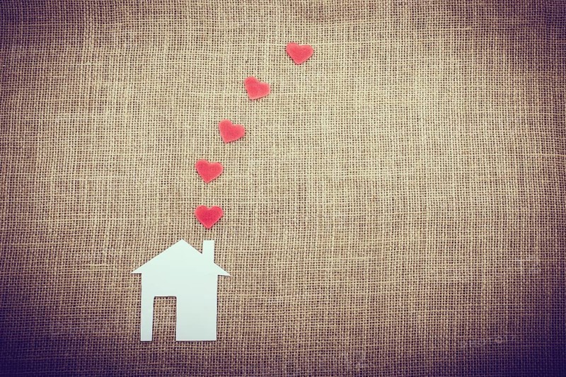 Heart shape coming out of chimney of paper house