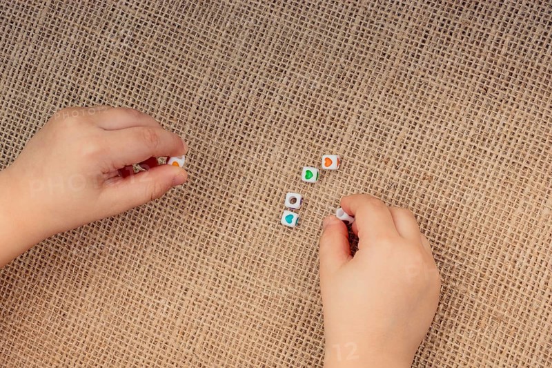 Little cubes with heart shape in hand on canvas