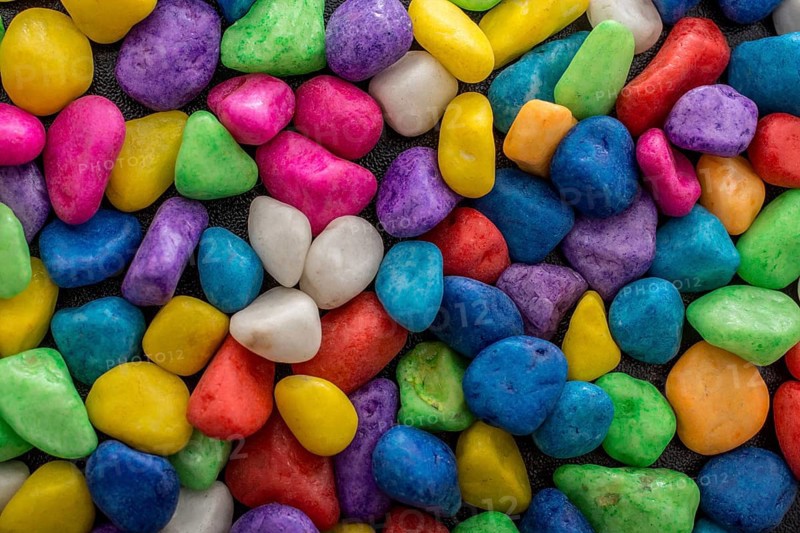Pile of little colorful pebbles as stone background