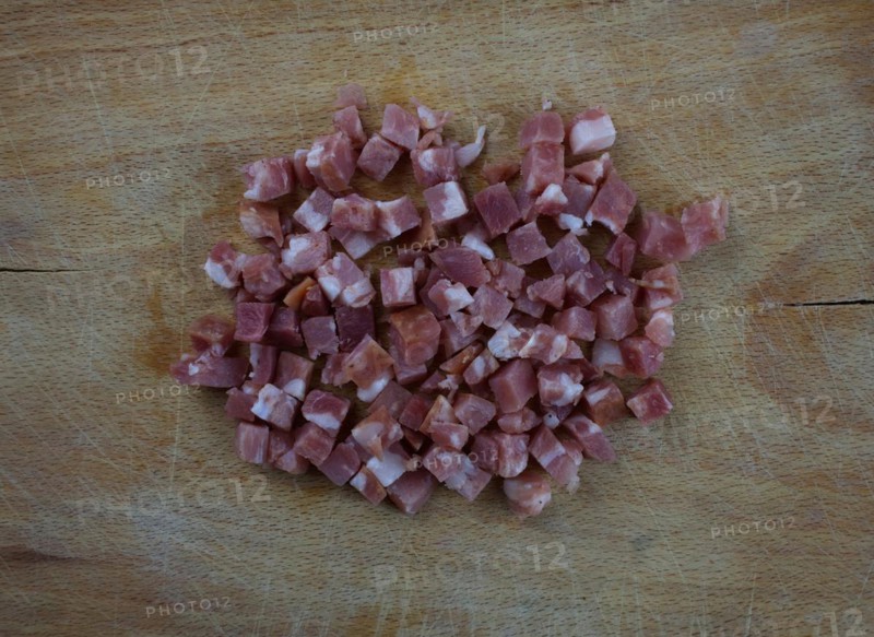 Diced ham on wooden board