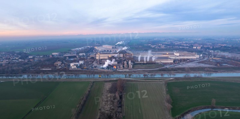 Drone aerial view of working steel plant at dawn