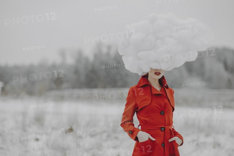 Woman in red coat with cloud on her head in the snow