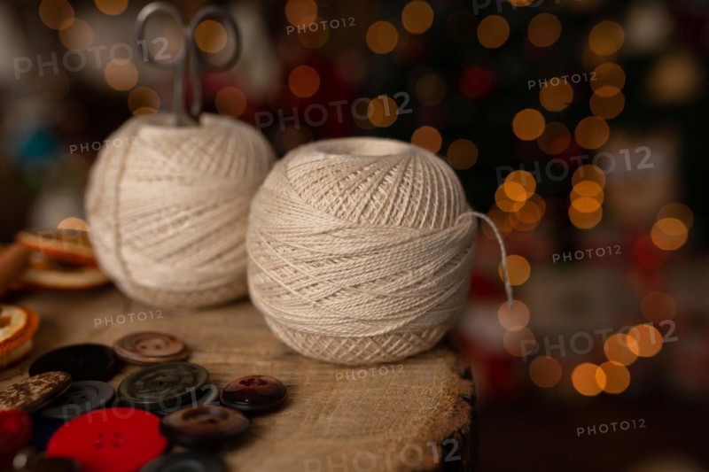 A Christmas scene with beautiful bokeh in the background and sewing tools. In studio