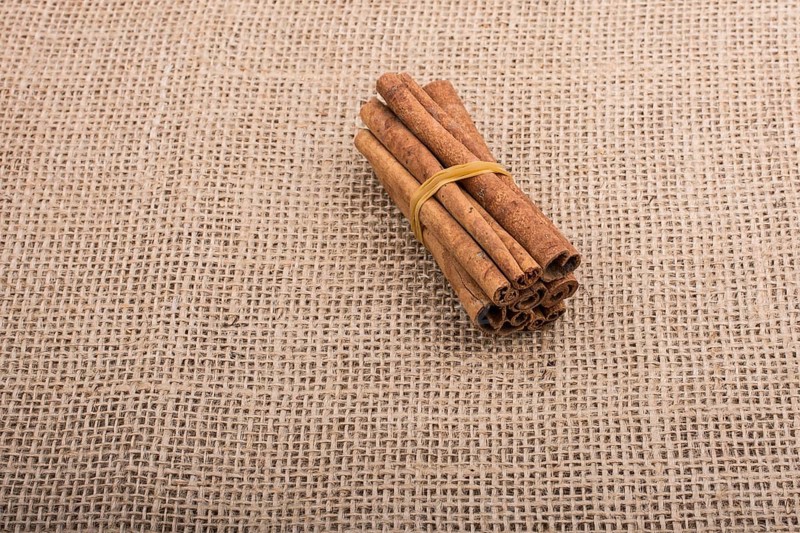 Bundle of cinnamon sticks on a linen canvas background