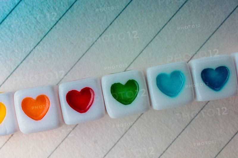Colorful cubes with a heart placed on paper
