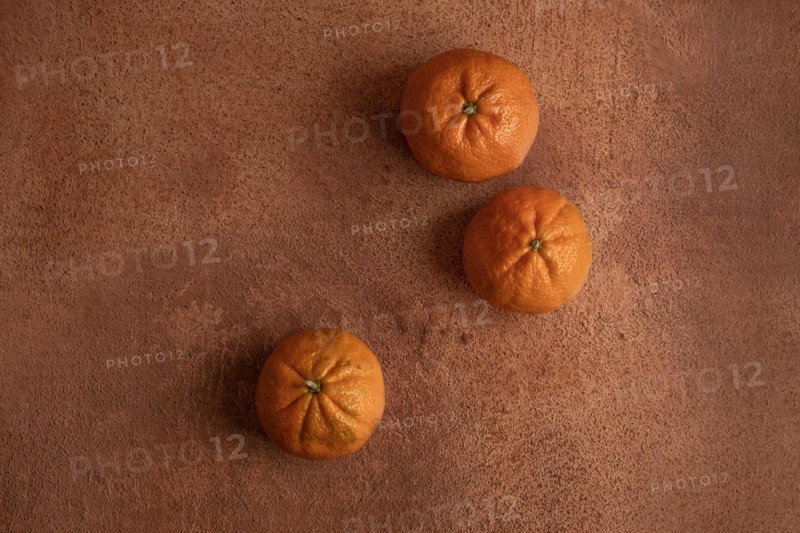 Top view of tangerines on orange background