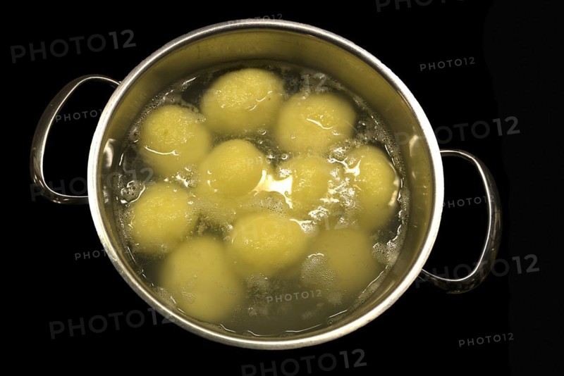 Potato dumplings in a pot of boiling water