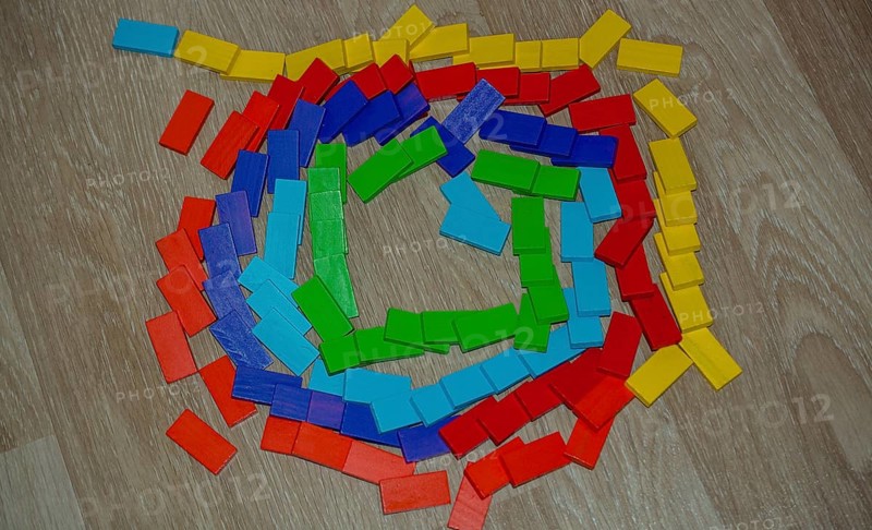 Colorful Domino Blocks in a line on a white background