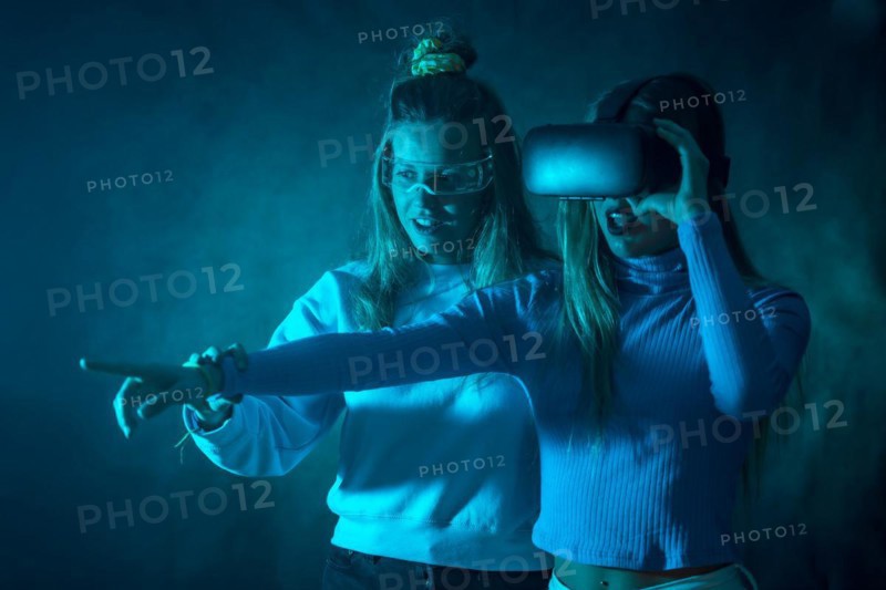 Two futuristic women in vr glasses