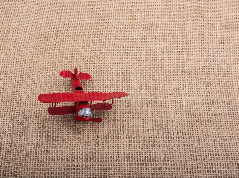 Toy airplane on a linen canvas background