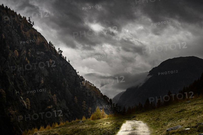 Autumnal mountain landscape with threatening cloudy sky
