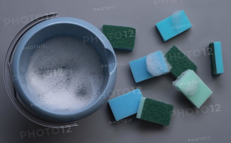 Many cleaning sponges with cleaning bucket and foam