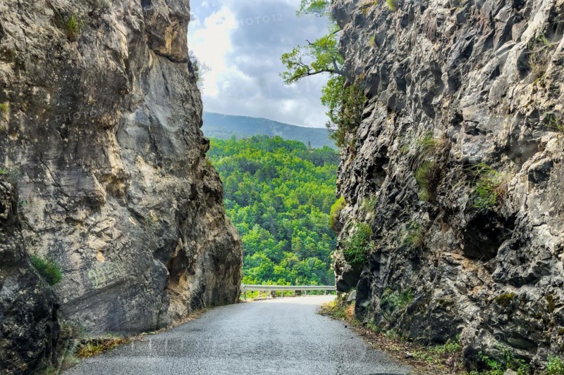 Narrow road Country road without markings through narrow rocky passage in mountainous landscape in southern France