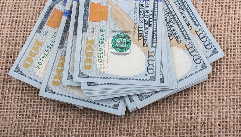 Banknote bundle of US dollar placed on a linen canvas