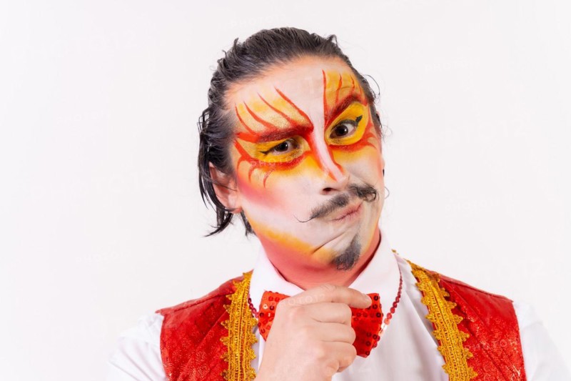 Portrait of smiling juggler with painted clown face isolated on white background