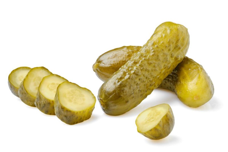 Pickled cucumbers whole and sliced isolated on white background
