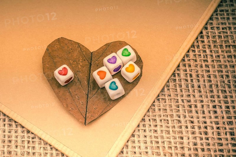 Colorful cubes with a heart on notebook on canvas