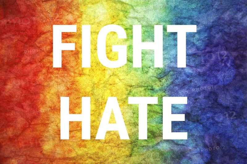 Fight hate words on LGBT textured background