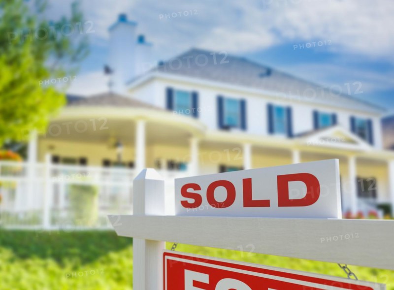 Sold for sale real estate sign in front of new house