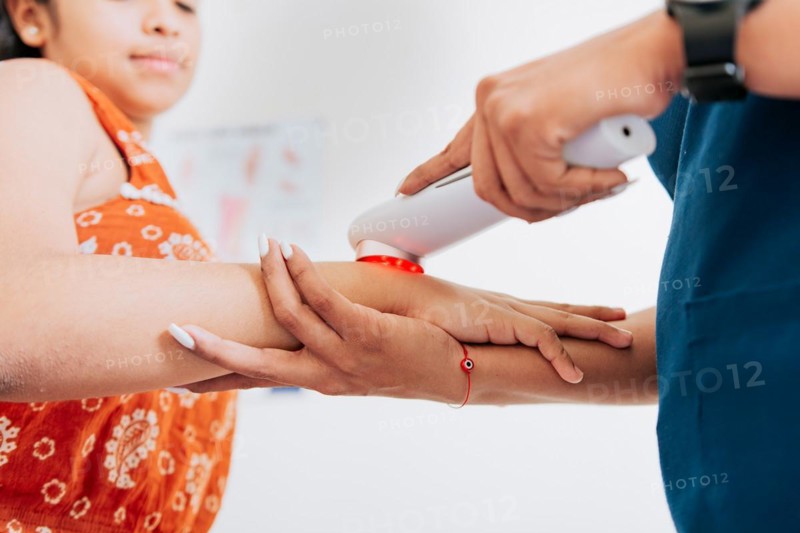 Laser therapy used on the arm to treat pain