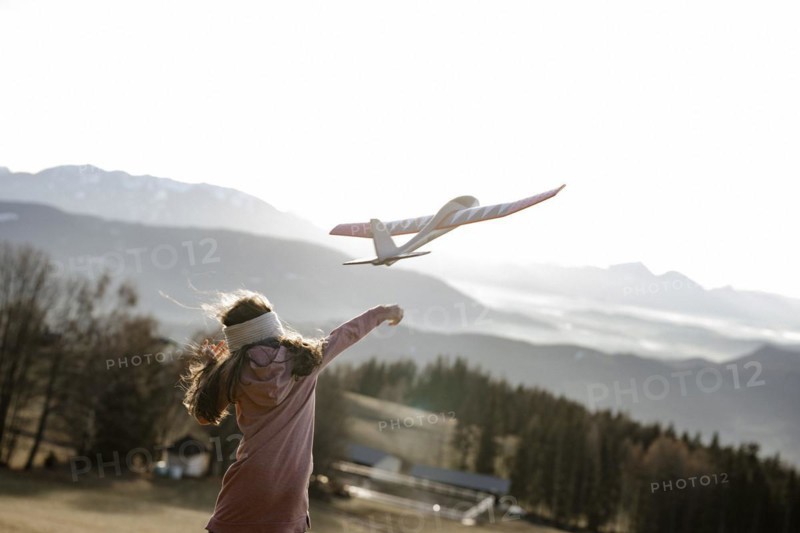 Girl playing with model glider