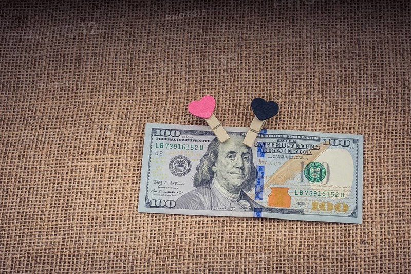 Heart icon bundle of US dollar placed on a linen canvas