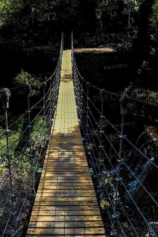 Close up of pedestrian suspension bridge in the view
