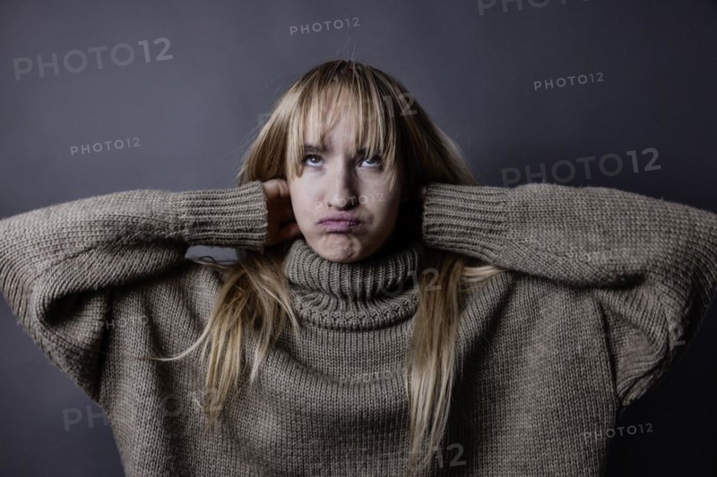 Young woman with long blond hair and a woollen jumper