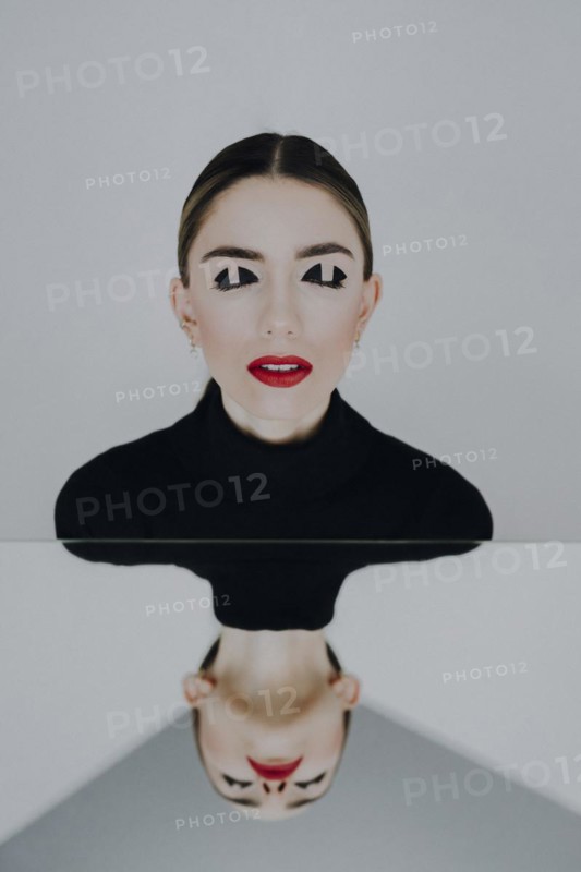 Woman with closed eyes reflected