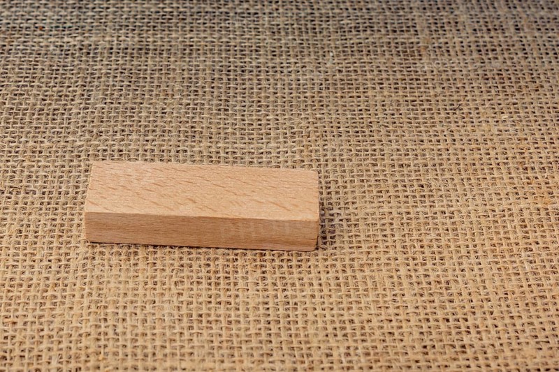 Wooden domino on a linen canvas background