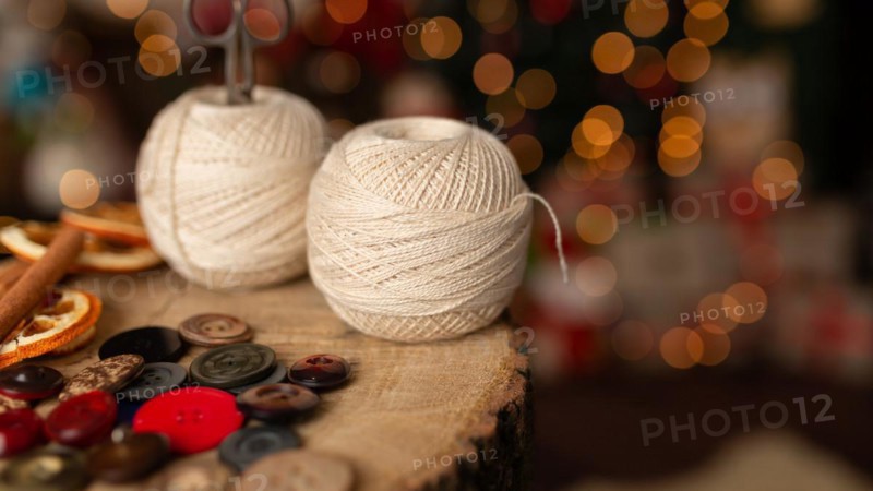 A Christmas scene with beautiful bokeh in the background and sewing tools. In studio