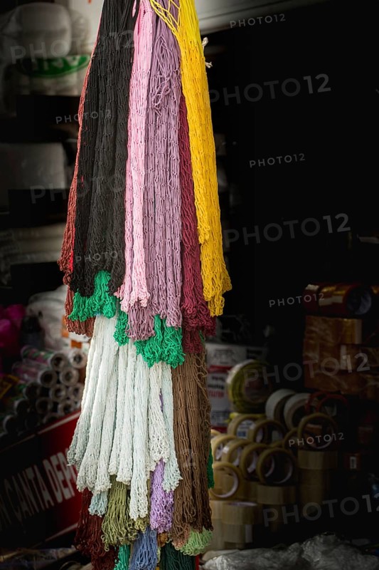 Empty mesh bags of various color at a market place