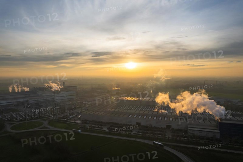 Drone aerial view of working steel plant at dawn