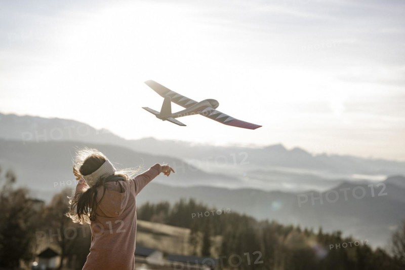 Girl playing with model glider