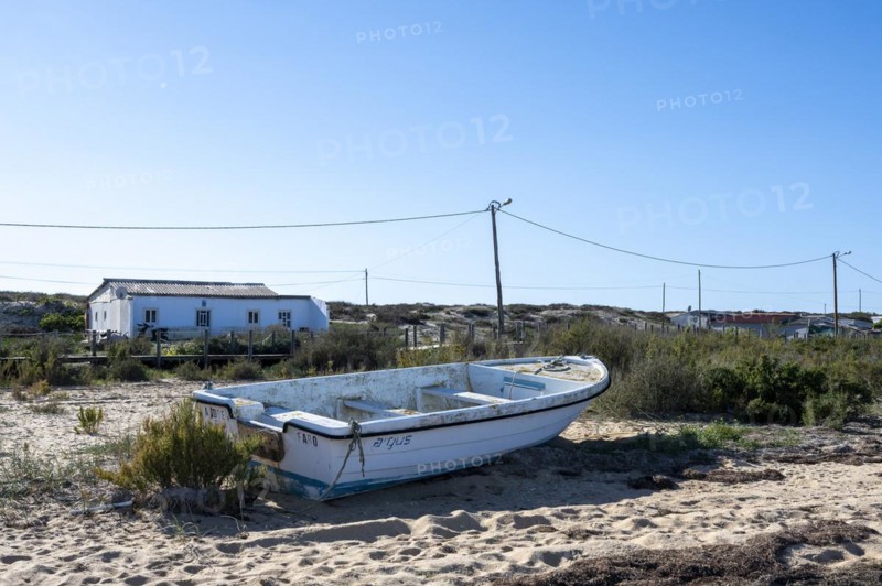 Fishing boat on the beach of the Ria Formosa nature park Park