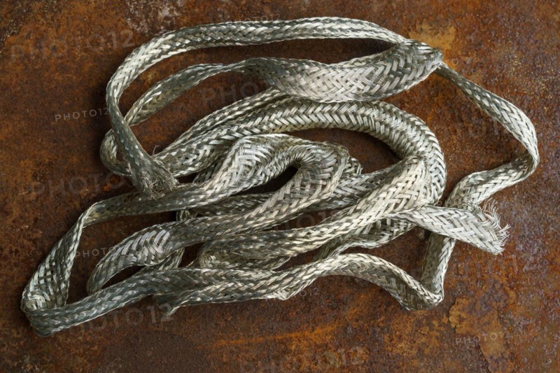 Silver metal copper wire scrap materials recycling of waste from manual wire tearing. Closeup of copper waste in the form of copper wires