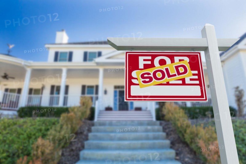 Sold for sale real estate sign in front of new house