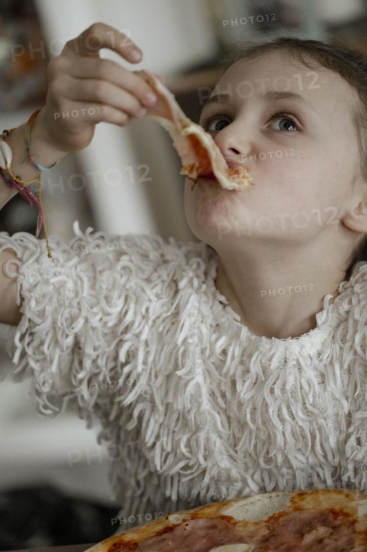 Girl eats a pizza