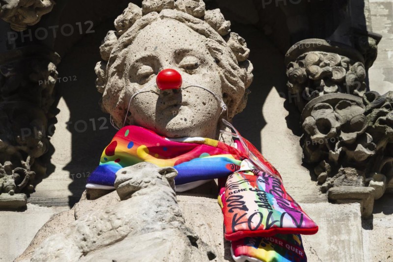 Saint Agnes draped with carnival scarf and red cardboard nose