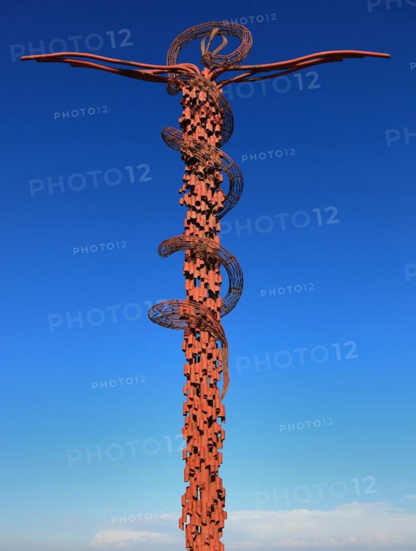 Cross entwined by a brass serpent