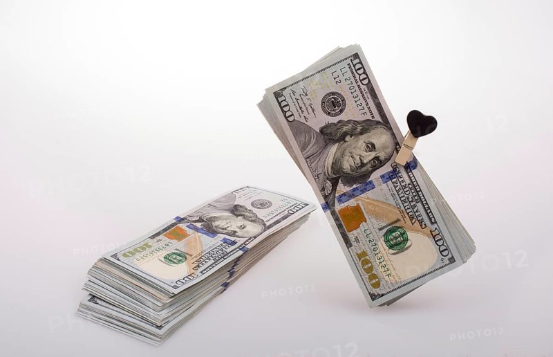 American 100 dollar banknotes with a heart clip on a string