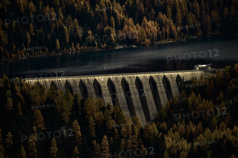 Dam of the Zufrittsee with autumnal mountain forest