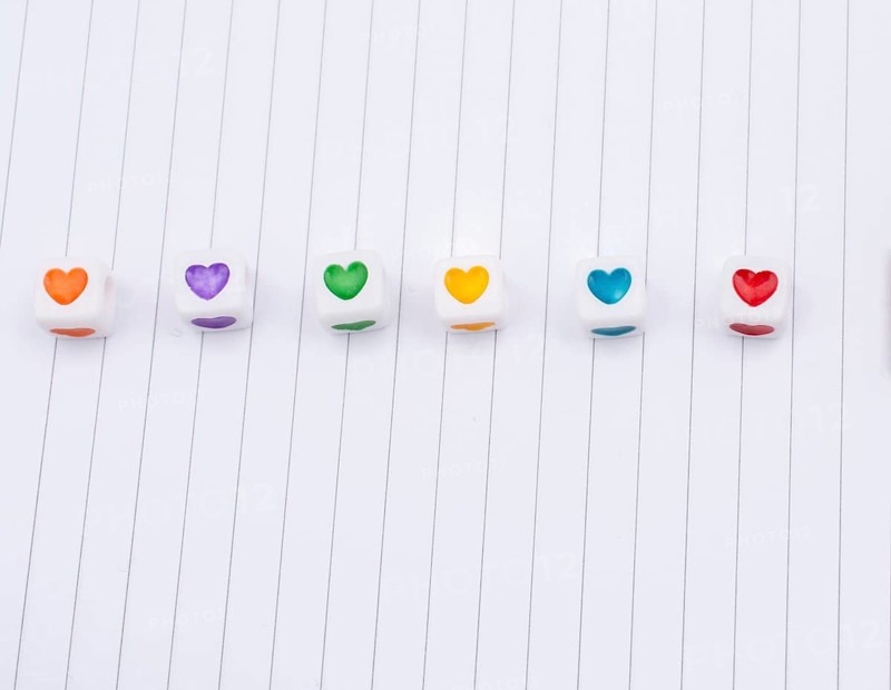Love cubes and paper arrow on a notebook