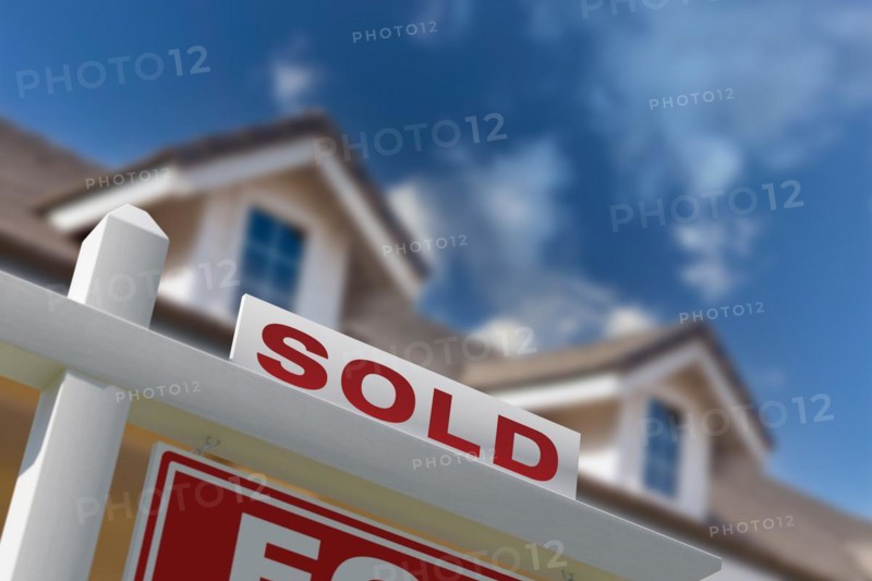 Sold for sale real estate sign in front of new house